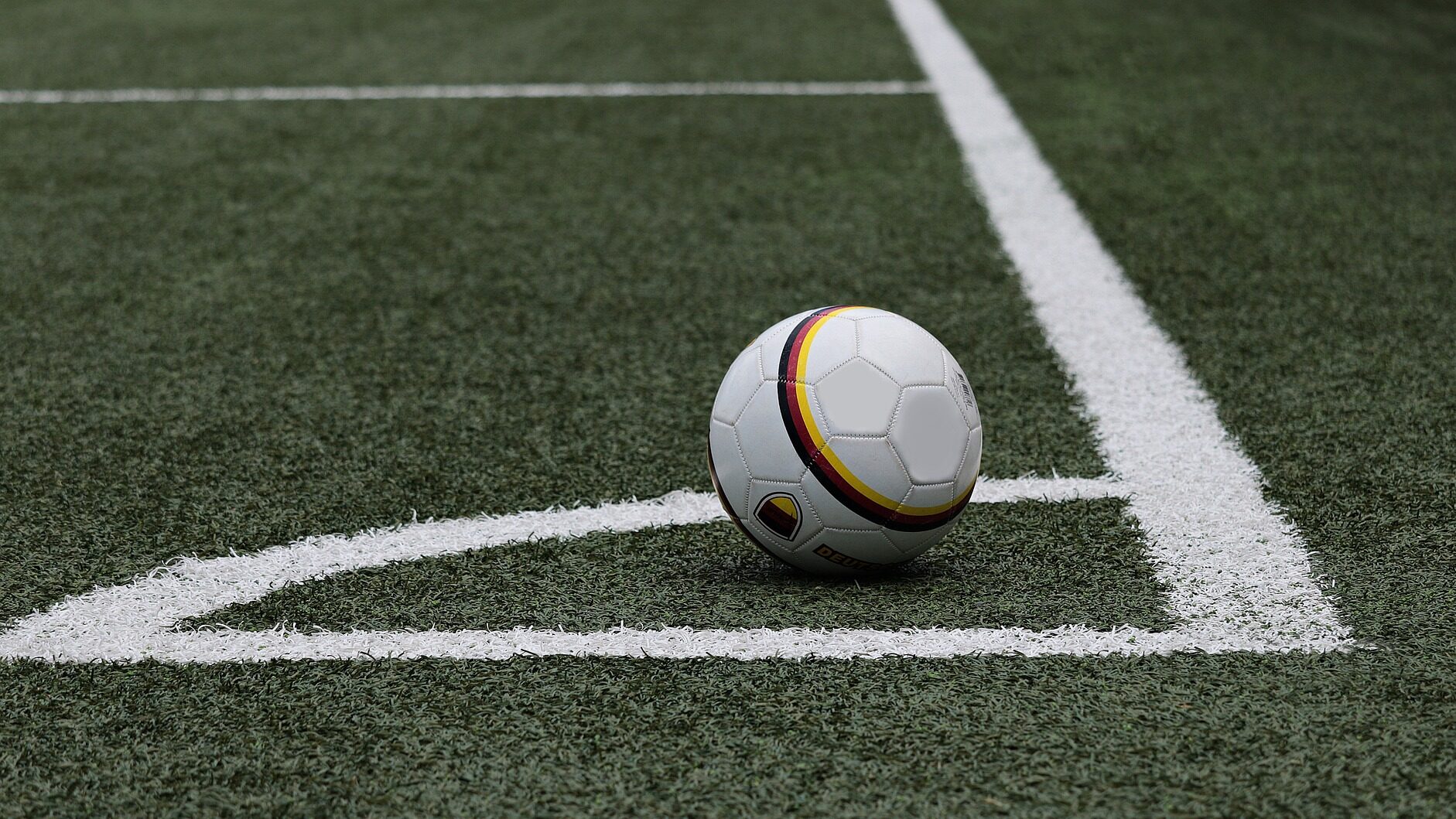 An image of a football/soccer ball in the corner quadrant of the pitch near the corner flag.